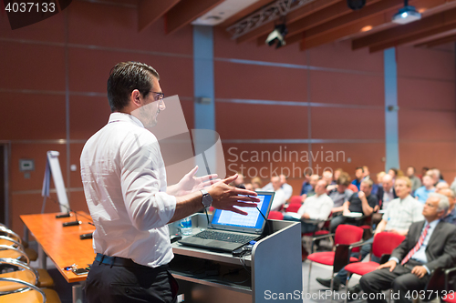 Image of Public speaker giving talk at Business Event.