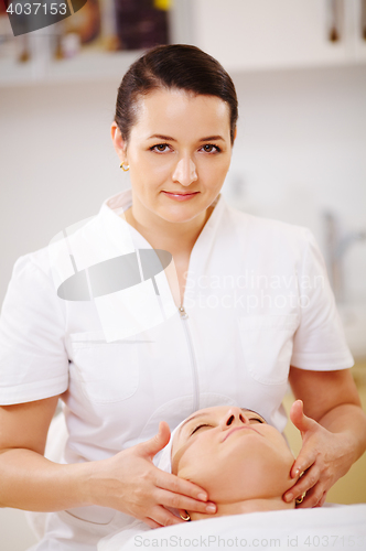 Image of Facial treatment with massage therapist during seance at beauty spa