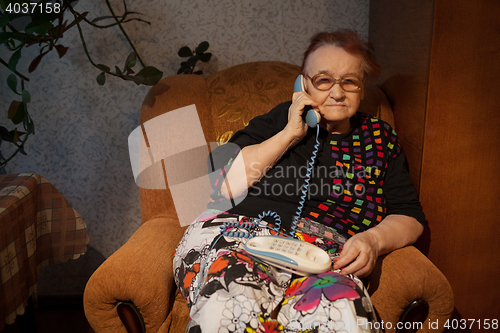 Image of Elderly woman talking on the home phone