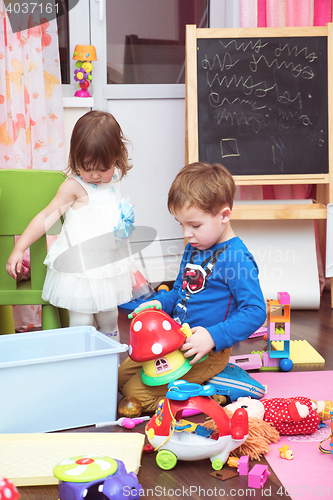 Image of Children playing with toys at home