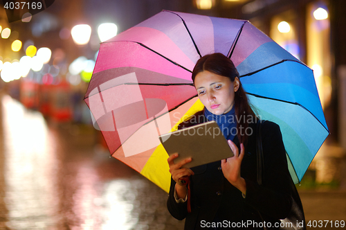 Image of Woman with Tablet PC in the Rain