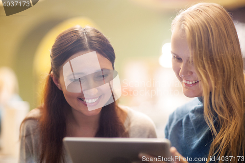 Image of Happy young girls spending time with pad