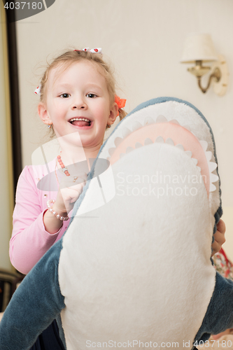 Image of Girl Playing with Plush Toy