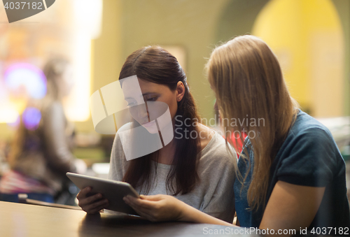 Image of Two women in the restaurant using electronic tablet