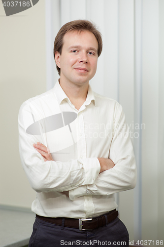 Image of Portrait of young confident man indoor