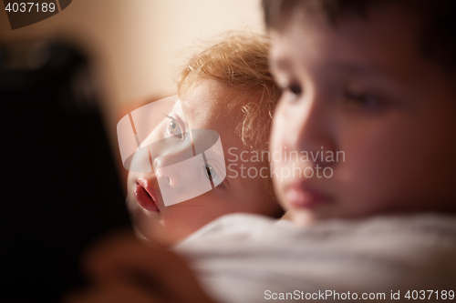 Image of Cute young child relaxing with his brother