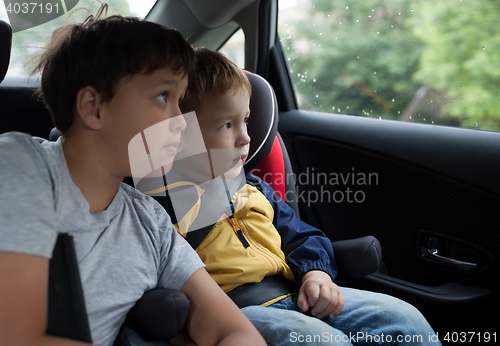 Image of Boys looking out the car window