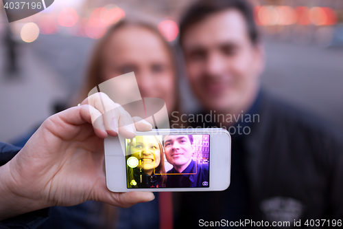 Image of Happy couple taking self portrait