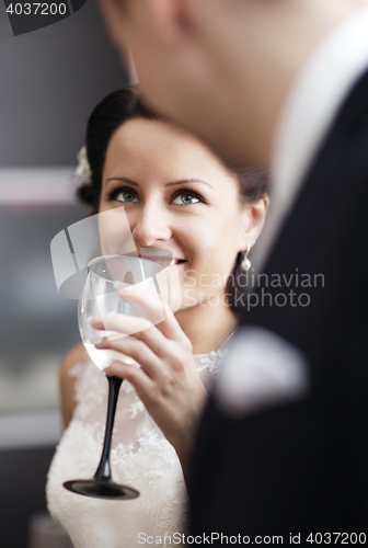 Image of Elegant woman drinking wine at a function