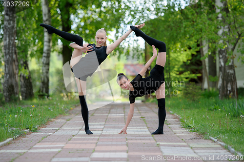 Image of Young gymnast girls posing outdoor