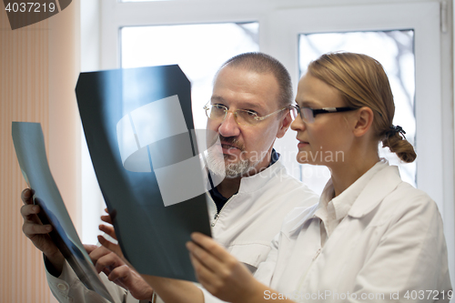 Image of Professor and young doctor comparing x-rays