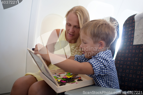 Image of Mother and son playing together in the plane