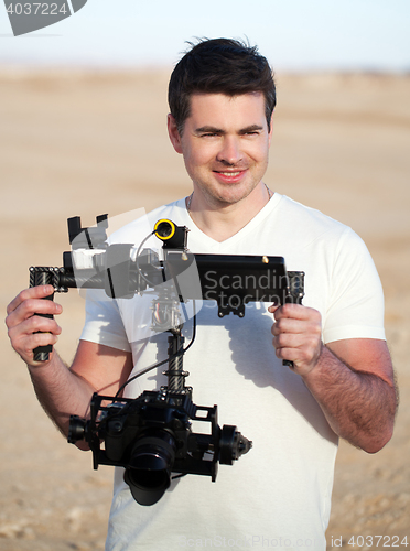 Image of Smiling man with steadicam equipment outdoor