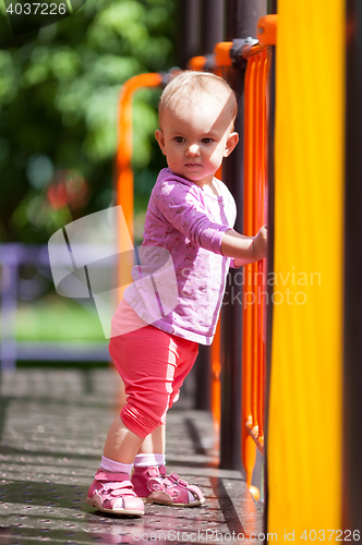 Image of Small infant standing in playground