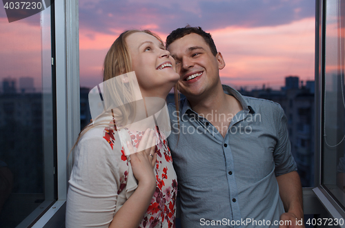 Image of Young happy couple on the balcony