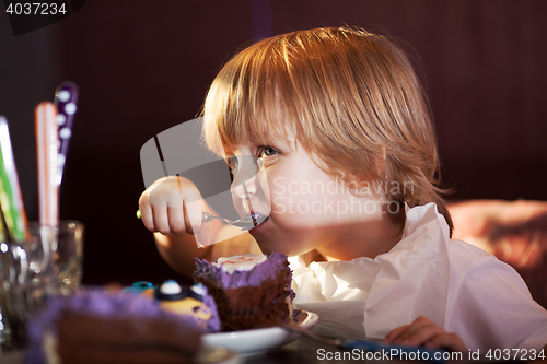 Image of Little boy eating chocolate cake