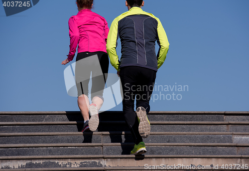 Image of young  couple jogging on steps