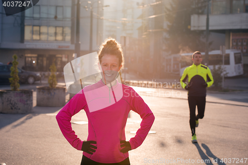 Image of woman  stretching before morning jogging