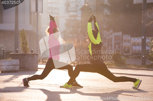 Image of couple warming up before jogging