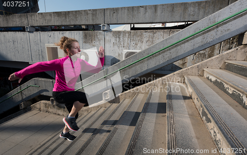 Image of woman jogging on  steps