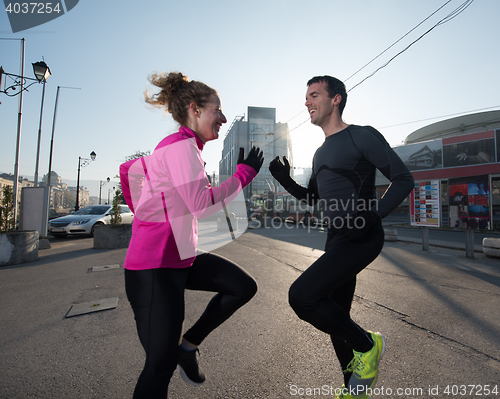 Image of couple warming up before jogging