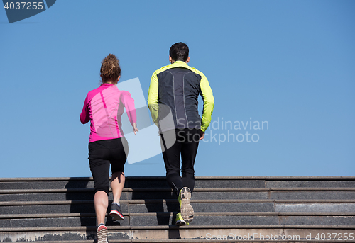 Image of young  couple jogging on steps