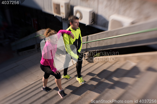 Image of young  couple jogging on steps
