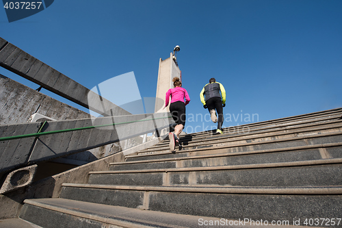 Image of young  couple jogging on steps