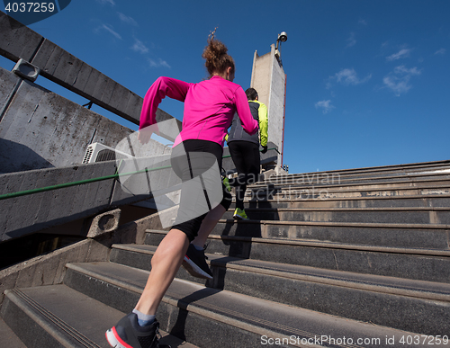 Image of woman jogging on  steps