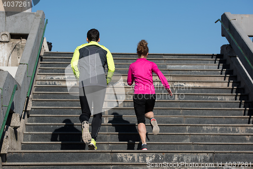 Image of young  couple jogging on steps