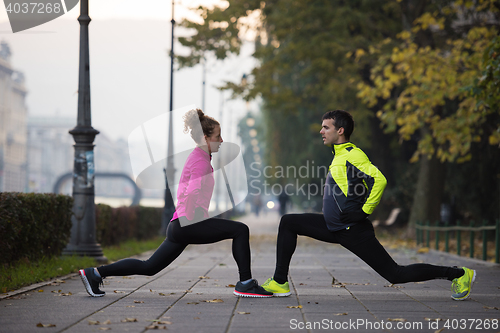 Image of couple warming up before jogging