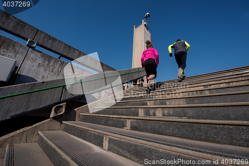 Image of young  couple jogging on steps