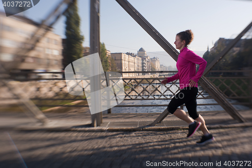 Image of sporty woman jogging on morning