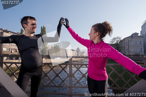 Image of couple warming up before jogging