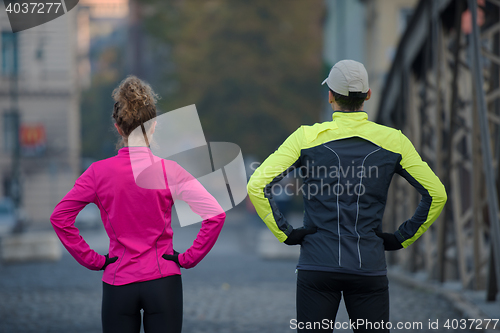 Image of couple warming up before jogging