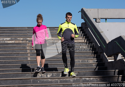 Image of young  couple jogging on steps