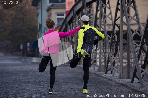 Image of couple warming up before jogging