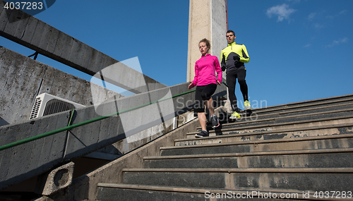 Image of young  couple jogging on steps