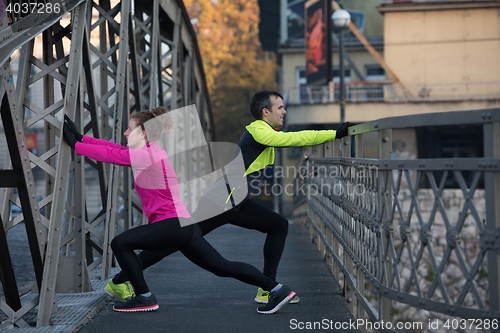 Image of couple warming up before jogging