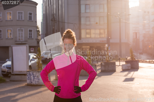 Image of woman  stretching before morning jogging