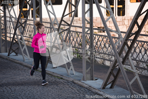 Image of sporty woman jogging on morning