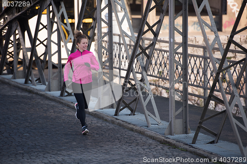 Image of sporty woman jogging on morning