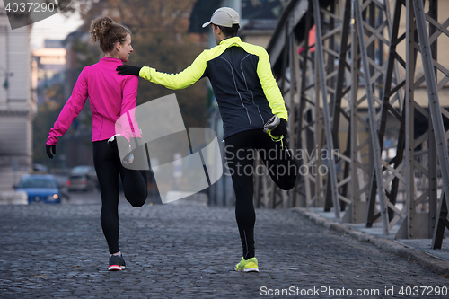 Image of couple warming up before jogging