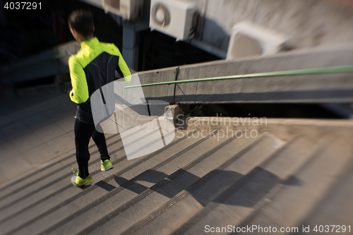 Image of man jogging on steps