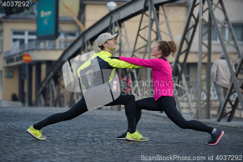 Image of couple warming up before jogging