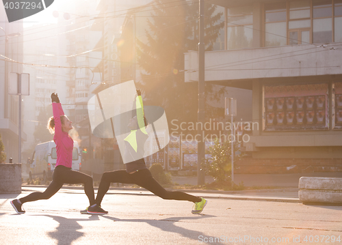 Image of couple warming up before jogging