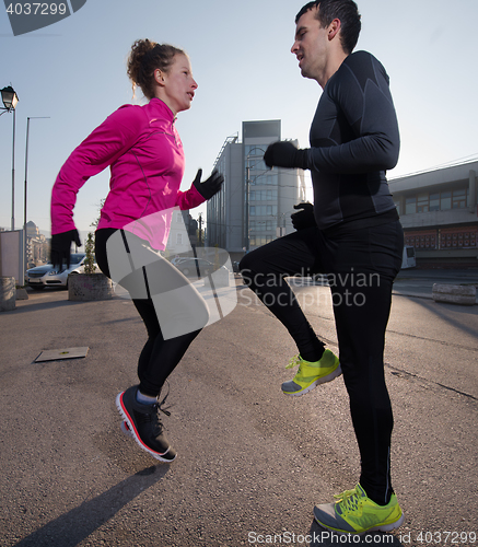 Image of couple warming up before jogging