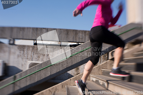 Image of woman jogging on  steps