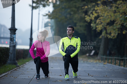 Image of couple warming up before jogging