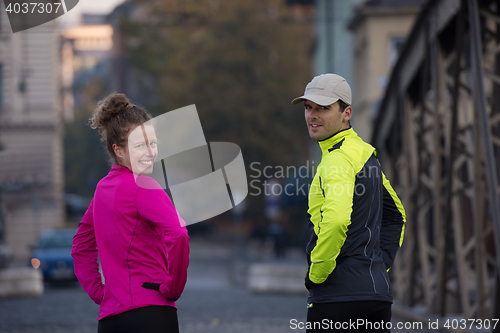 Image of couple warming up before jogging